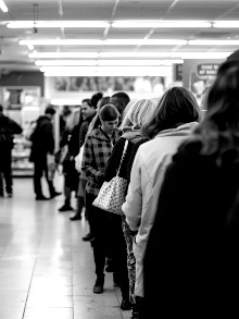 People waiting in line at a pharmacy – Medicare Part D enrollment season concept